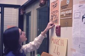 Student looking at posters at Queensway Campus : [photograph]