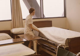 Photograph of a Nursing Student Making a Hospital Bed