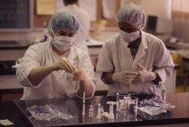Photograph of a Pharmacy Assistant Students Preparing a Syringe