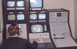 Photograph of an IMC staff member operating a video control console