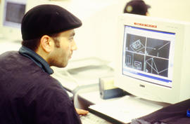 A photograph of an Architectural program student working on a computer