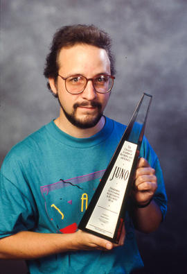 Photograph of Brian Dickenson holding his JUNO award