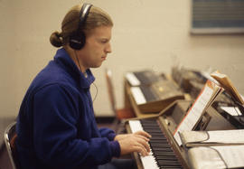 Photograph of a Music Student Practicing on an Electronic Keyboard