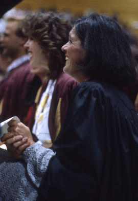 Photograph of graduates smiling during a convocation ceremony