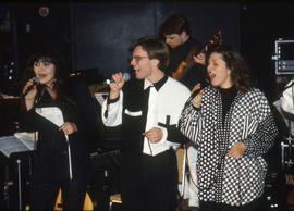 Photograph of a vocal trio performing on stage