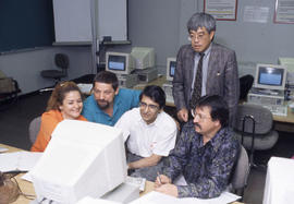 Photograph of instructor and students in the computer lab