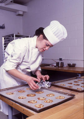 Photograph of a culinary student using a cutting mold