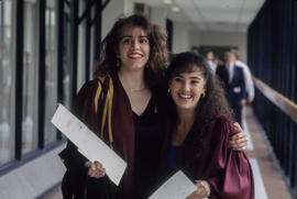 Photograph of two students in graduation garb at their convocation ceremony