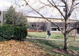 Photograph of a student walking through the courtyard at Lakeshore campus