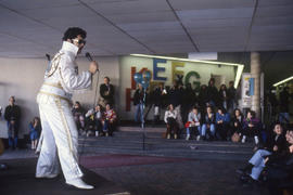 Photograph of an Elvis impersonator performing on stage