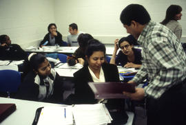 Photograph of an IT instructor and students