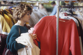 Photograph of a person admiring an item of clothing