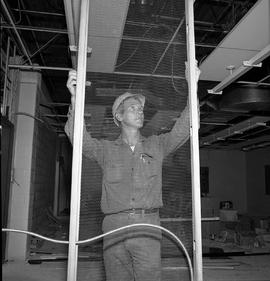 Photograph of a sub-foreman holding a lath