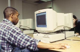 A photograph of a student on the computer