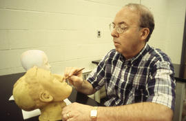 A photograph of a Funeral Services student working on a mannequin