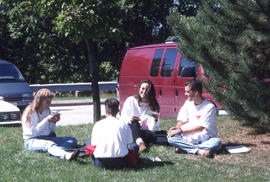 Photograph of Students Sitting on The Lawn Talking