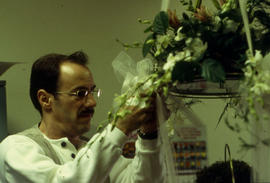 A photograph of a Retail Floriculture student preparing a floral arrangement