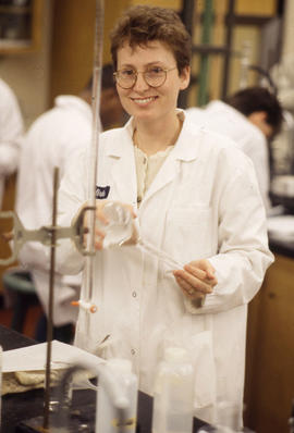 Photograph of a Pharmacy Assistant Student Holding a Container With Liquid