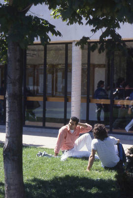 Photograph of students on the grass in front of D building