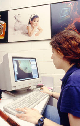 A photograph of a Photography student working at a computer