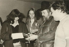 Photograph of Ronnie Hawkins Signing Autographs