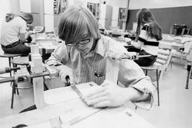 Photograph of a Woodworking Student Smoothing out Wood