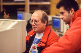 Photograph of two students collaborating at a PC workstation