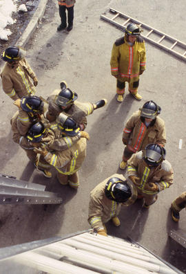 A photograph of Firefighting students ascending ladders
