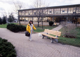 Photograph of someone walking through the courtyard at Lakeshore Campus