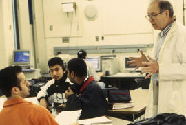 Photograph of Roy Fraser instructing students in class