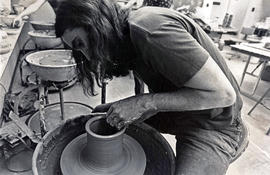 Photograph of a Fine Arts Student using a Pottery Wheel in Class