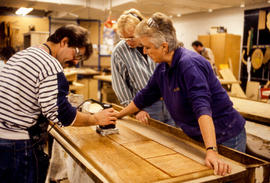 Photograph of student and faculty working on a woodworking project