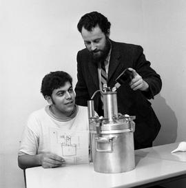 Photograph of an instructor working with a student at a pressure vessel