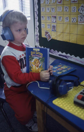 Photograph of a toddler in the daycare centre listening to a story