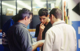 Photograph of faculty member working with students