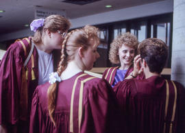 Photograph of graduating students conversing together