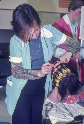 Photograph of a Student Practicing Hairdressing on a Mannequin