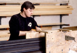 Photograph of a Theatre student working on material for a set