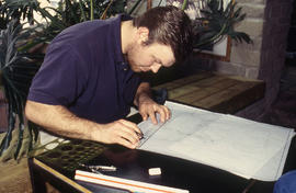 Photograph of a student working on diagrams