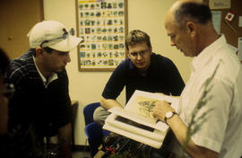 Photograph of Landscape students and professor looking at a book