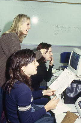 A photograph of three students working together at a computer
