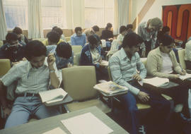 Photograph of students working a classroom with Janet McVicar