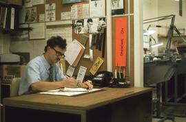 Jim Brady at his desk : [photograph]