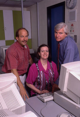 Photograph of three staff members in the HRT computer lab