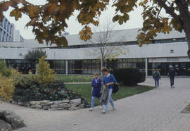 Photograph of persons on a walkway at North