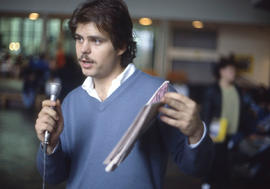Photograph of a person with a microphone