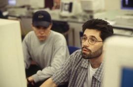 A photograph of two students working at a computer