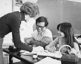 Photograph of a Faculty Member Working with Students in an ESL Classroom