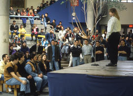 Photograph of an audience attentive to a speaker onstage