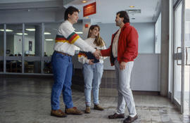 Photograph of student ambassadors greeting a visitor at the main college entrance